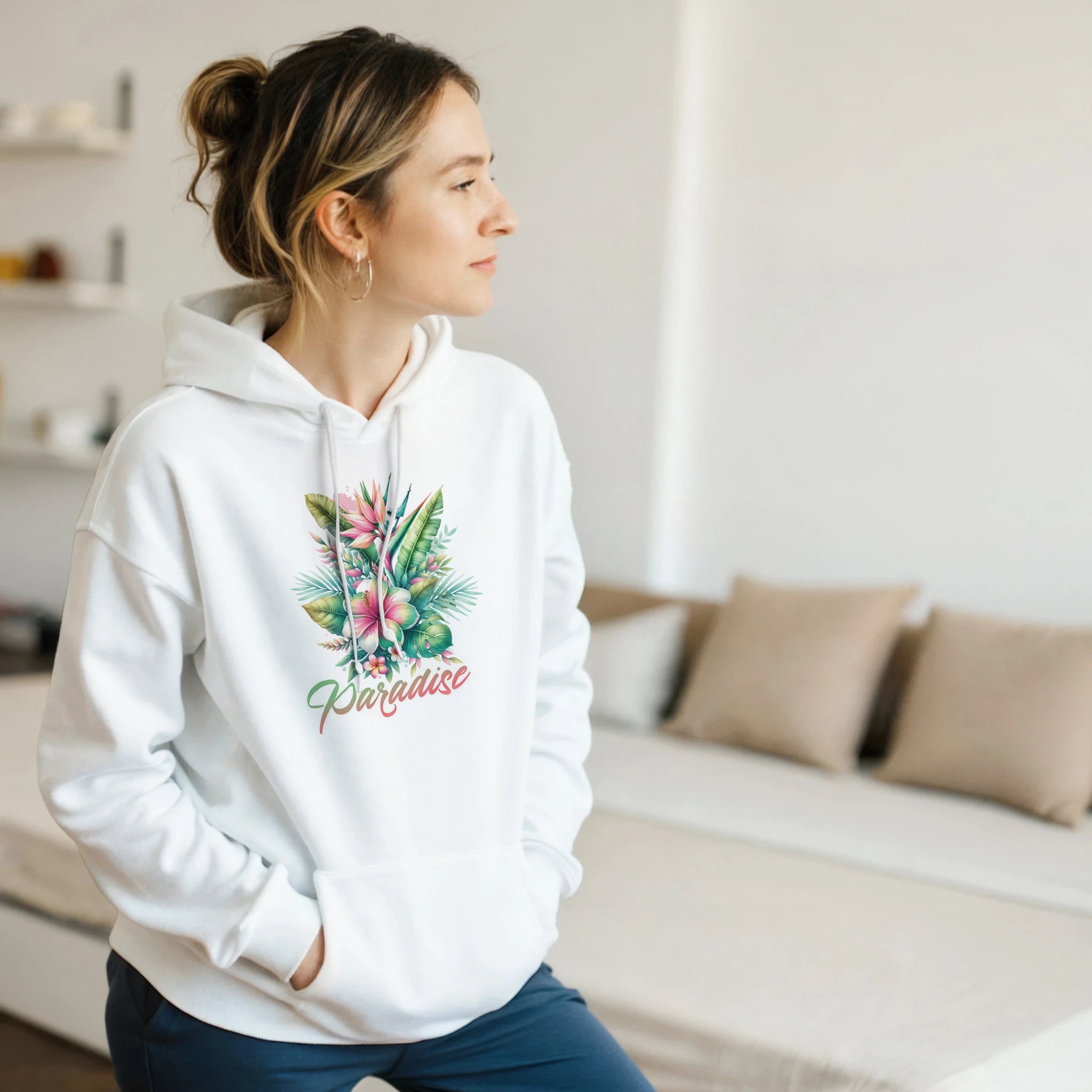 Woman wearing white Y2K Paradise hoodie featuring tropical palm leaves design and 'Paradise' script.