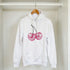 White hoodie with pink glitter cherries graphic, front pocket, drawstring hood, 50/50 cotton-polyester
