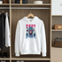 White hoodie with colorful graphic design hanging in a wardrobe.