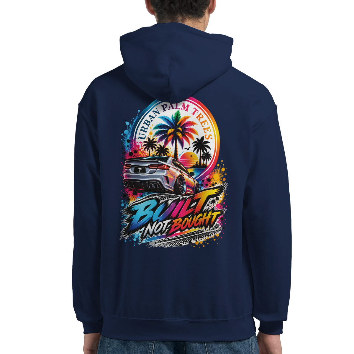 Navy blue hoodie back featuring colorful "Built Not Bought" graphic with modified car, palm trees, and sunset design.
