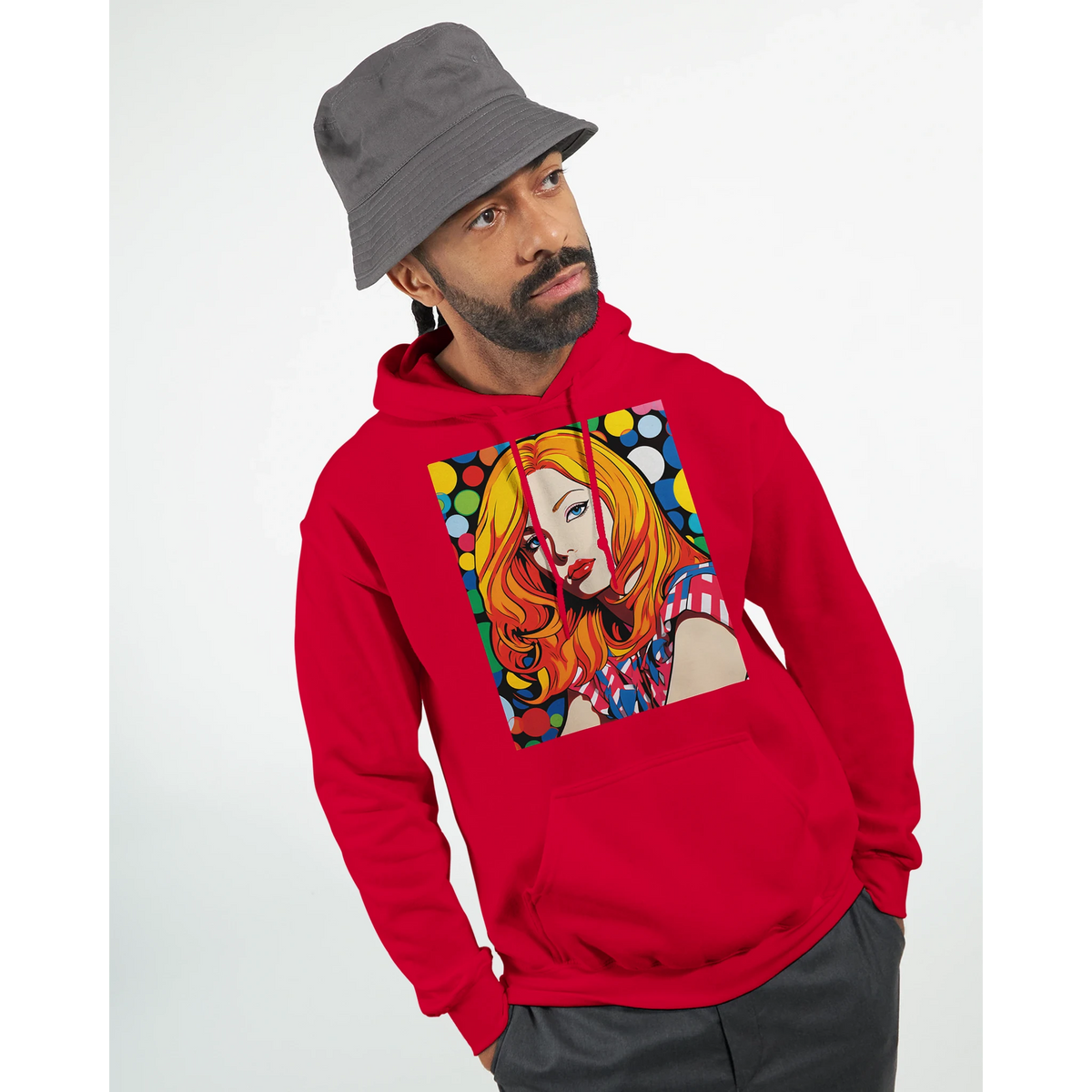 Man in a red hoodie with bold pop-art graphic and gray bucket hat, gazing sideways.