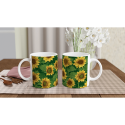 Three ceramic sunflower coffee mugs with bright yellow print on a checkered table.