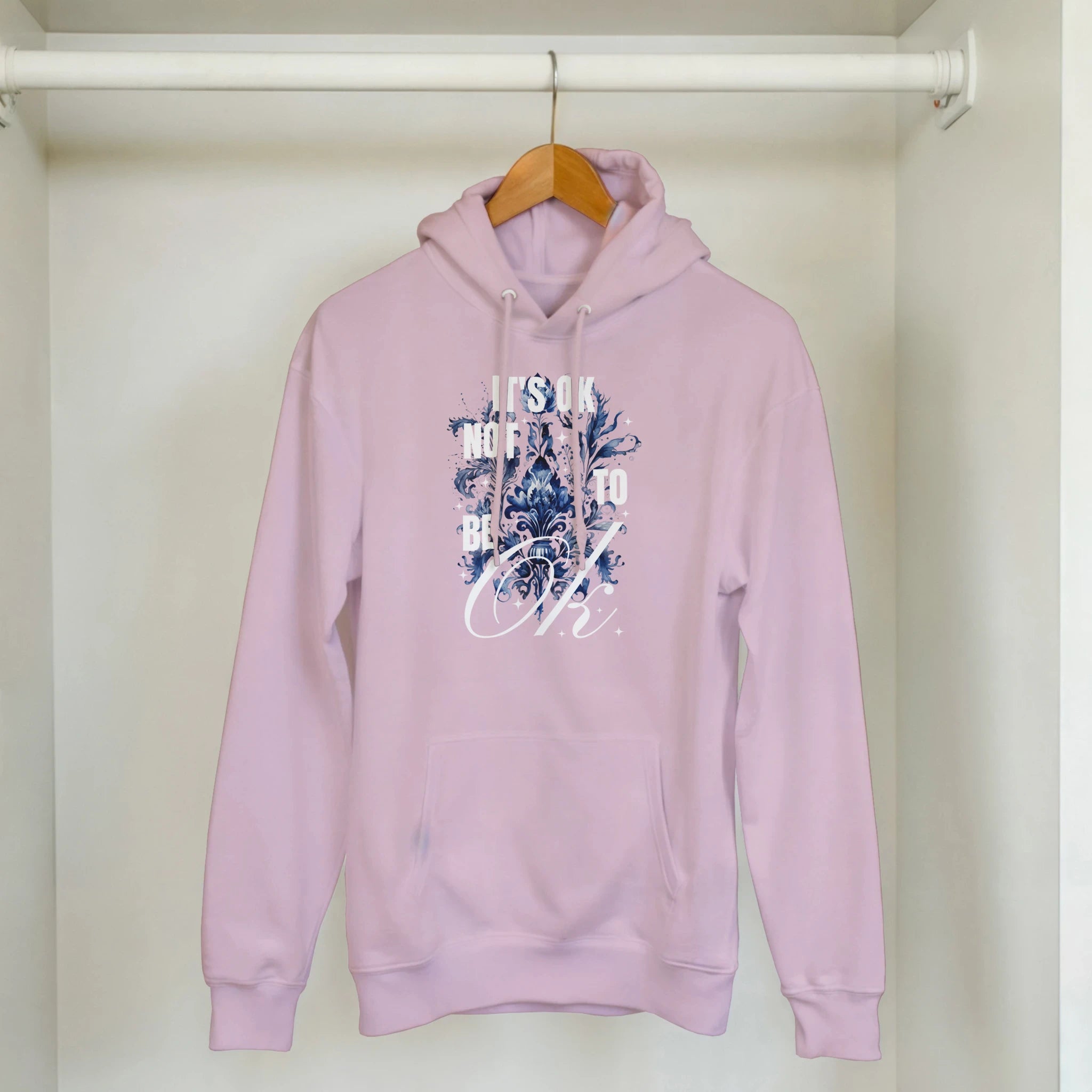 Lavender women's hoodie with blue floral graphic, front pocket, and Its OK Not To Be OK slogan.