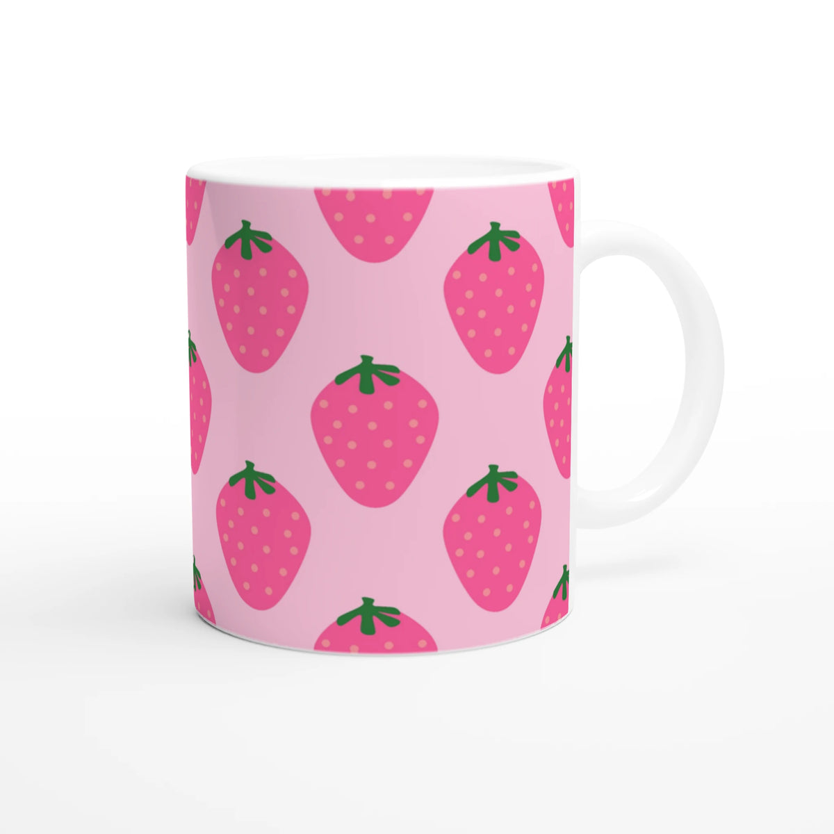 Cute pink strawberry mug with green leaves pattern and white handle.