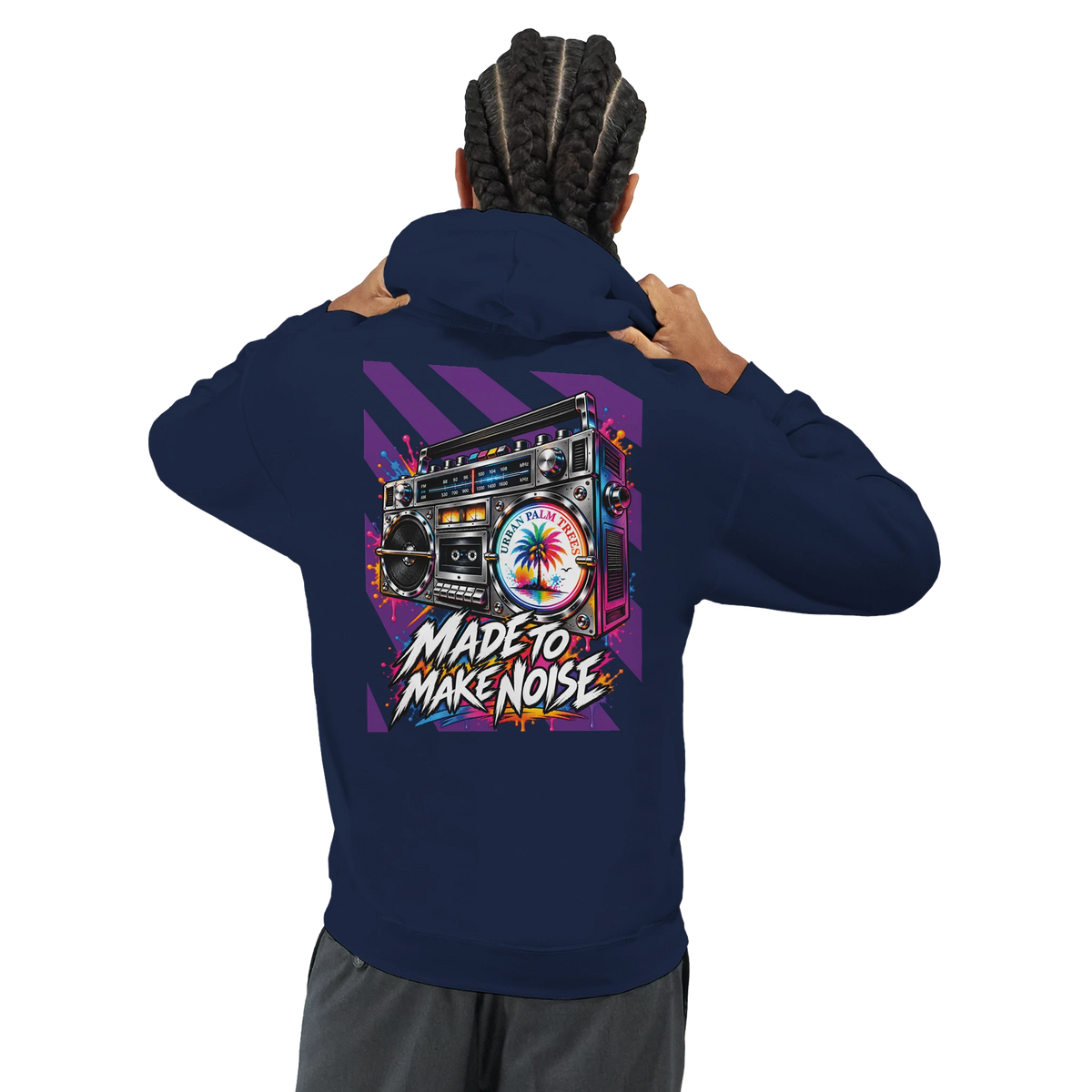 Man wearing navy hoodie featuring retro boomback graphic with palm tree and "Made to Make Noise" text on the back.