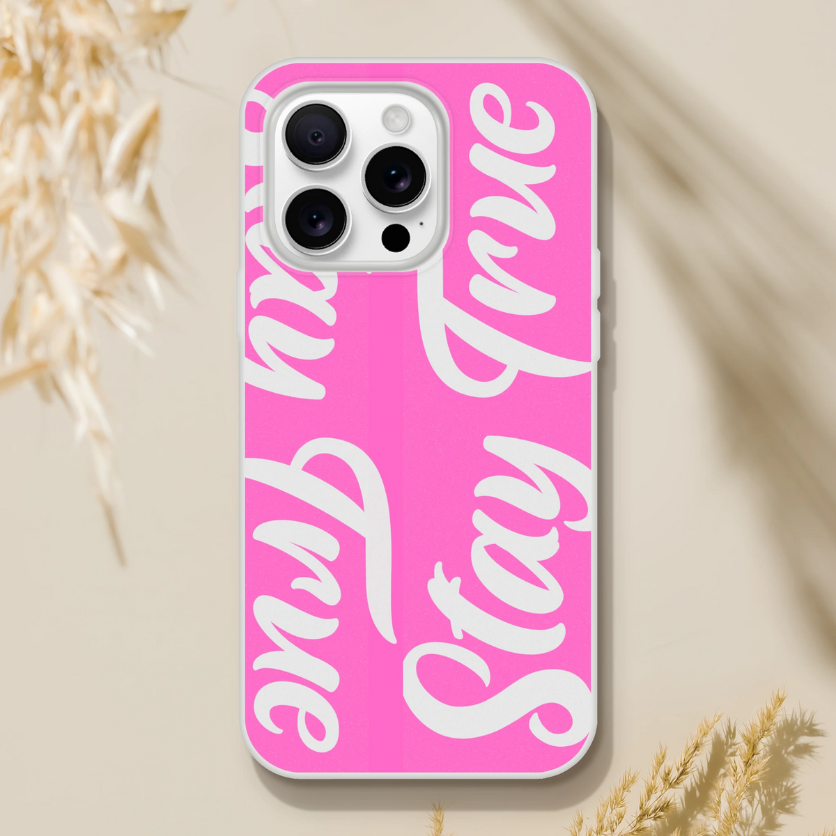 Pink iPhone case with Stay True slogan in white script for iPhone 13–16.