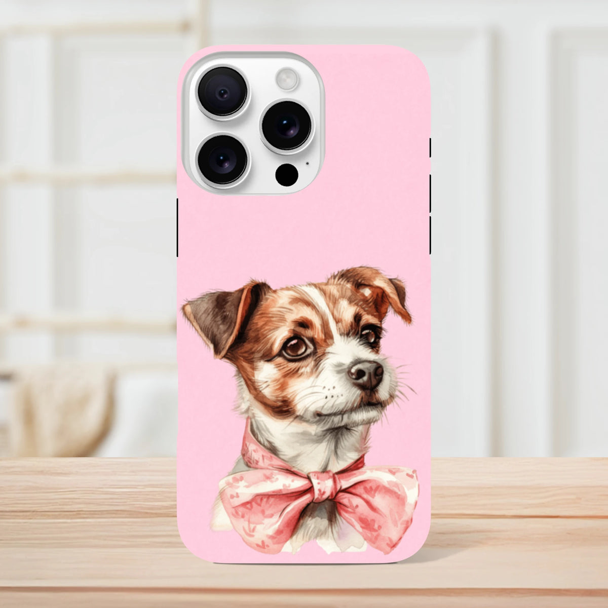 Pink iPhone case featuring a cute brown and white puppy wearing a floral pink bow tie on a shock-absorbent shell.