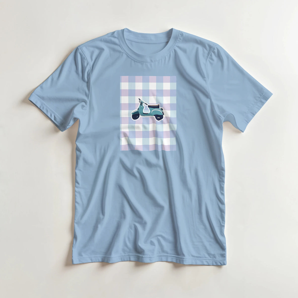 Pastel blue retro gingham graphic tee featuring a cute scooter illustration for women. Perfect for streetwear styling with cargos or denim.