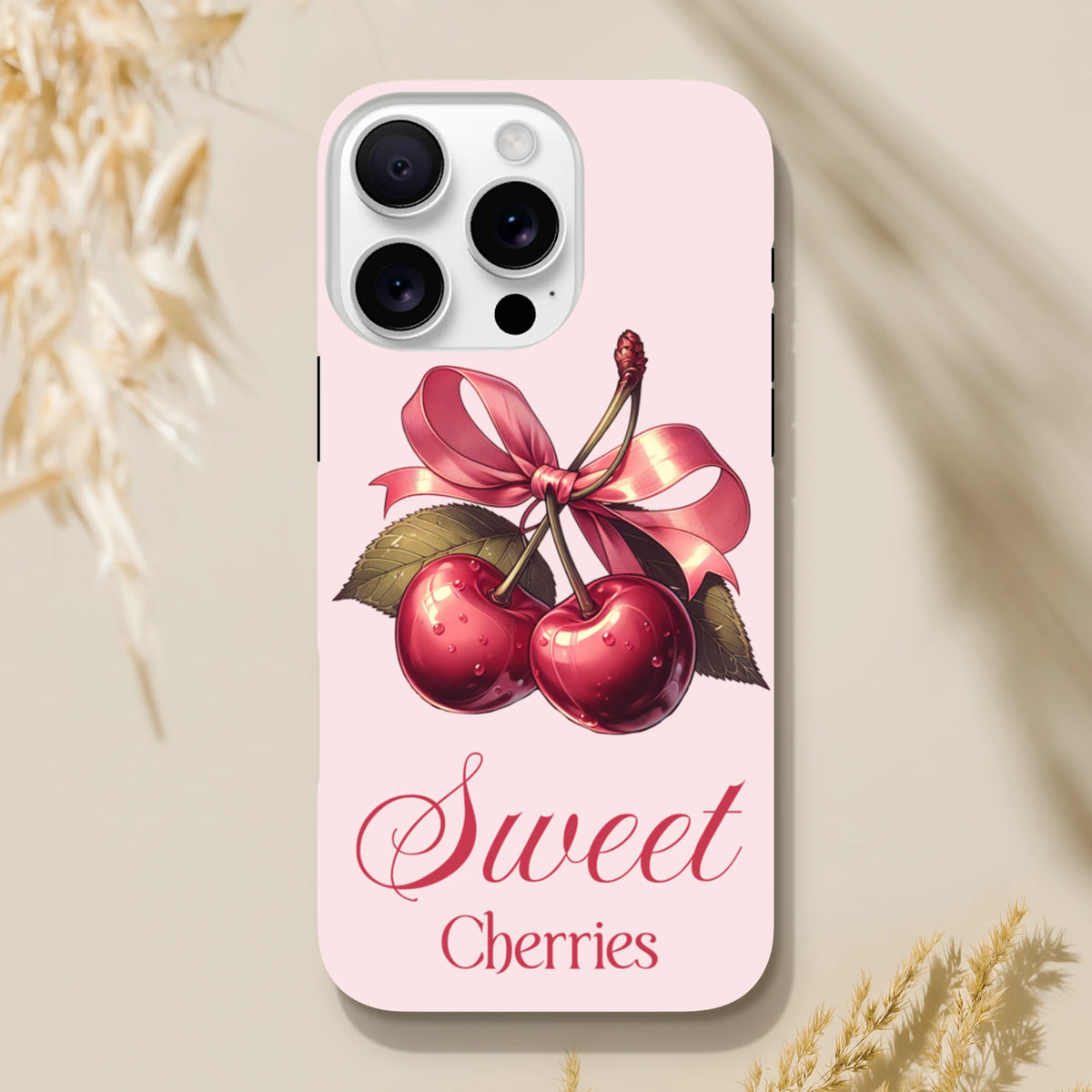 Pink iPhone case featuring retro cherries with a vintage pink bow and Sweet Cherries script text.