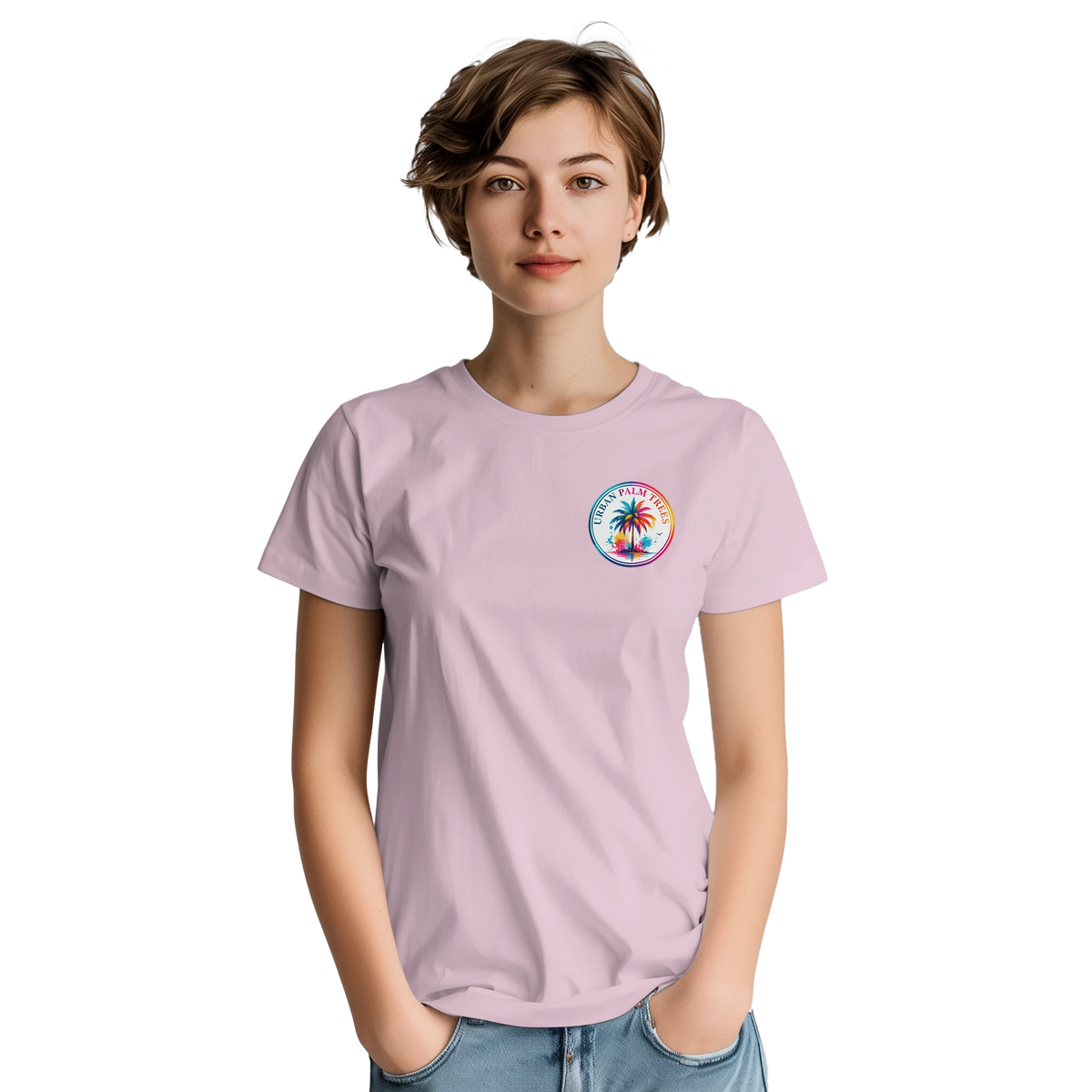 Woman wearing a light pink graphic tee with a colorful retro Urban Palm Trees circle logo on the chest.