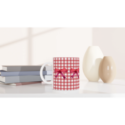 Red Gingham Bow Mug on a white desk beside a red gingham gift box with a ribbon.