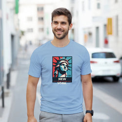 Man wearing light blue New York graphic T-shirt with Statue of Liberty artwork; sizes S–XL.