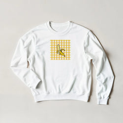 White sweatshirt featuring a retro yellow gingham square graphic with a peeled banana illustration for women.
