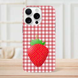 Red gingham iPhone case featuring a large bright red strawberry graphic, offering rugged drop protection for daily use.