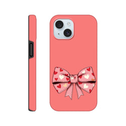 Pink tough iPhone case featuring a coquette heart-patterned bow graphic for stylish protection on iPhone 13-16.