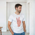 Man wearing Peace Men's Graphic T-Shirt in white with red peace hand sign graphic.