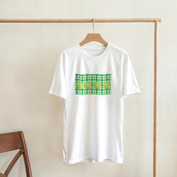 White T-shirt with lime gingham graphic on front, hanging on a wooden hanger.