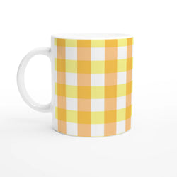 Yellow gingham ceramic mug with orange-yellow checks and white handle.