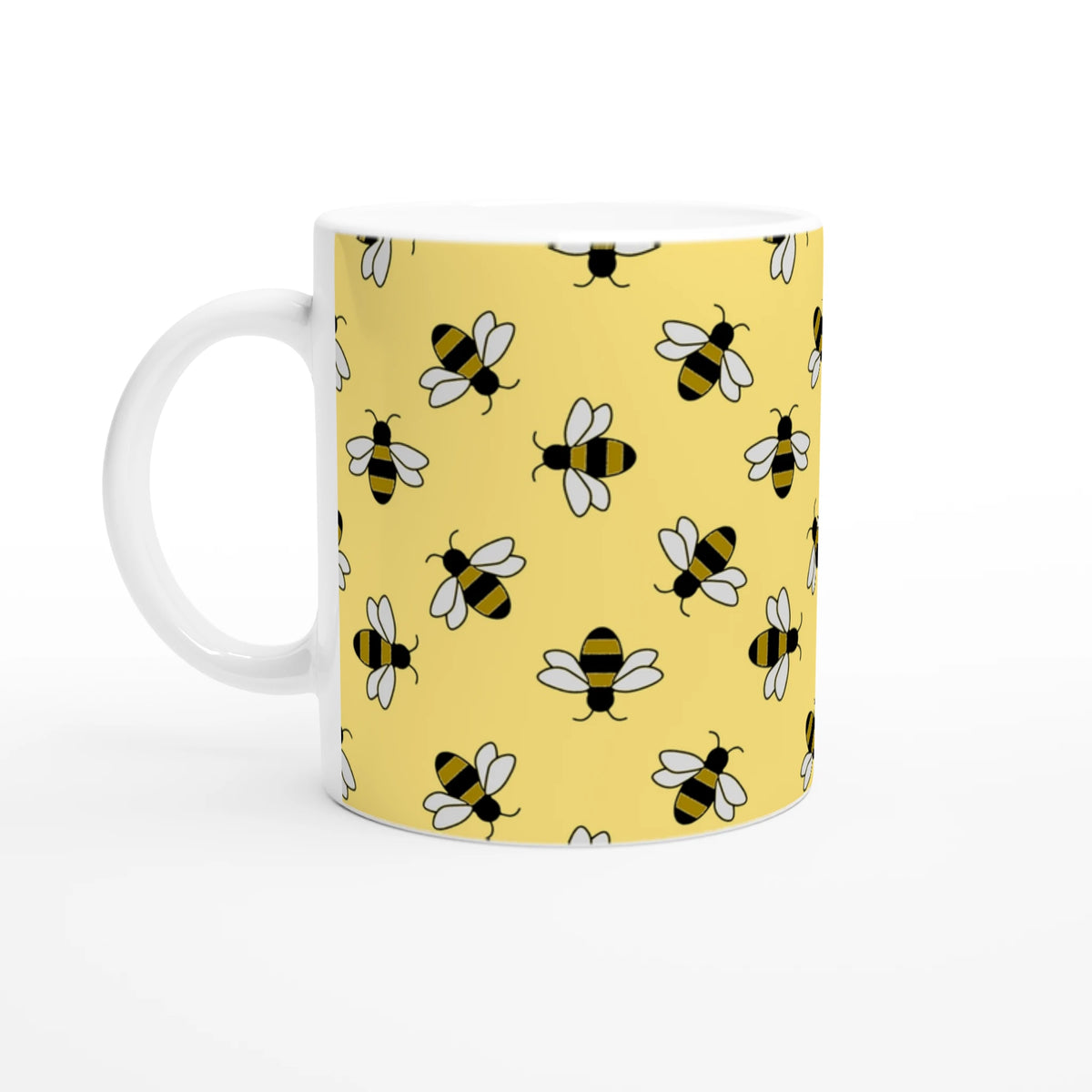 Cute bee-themed yellow ceramic mug with a repeating bee pattern, perfect for coffee or tea.
