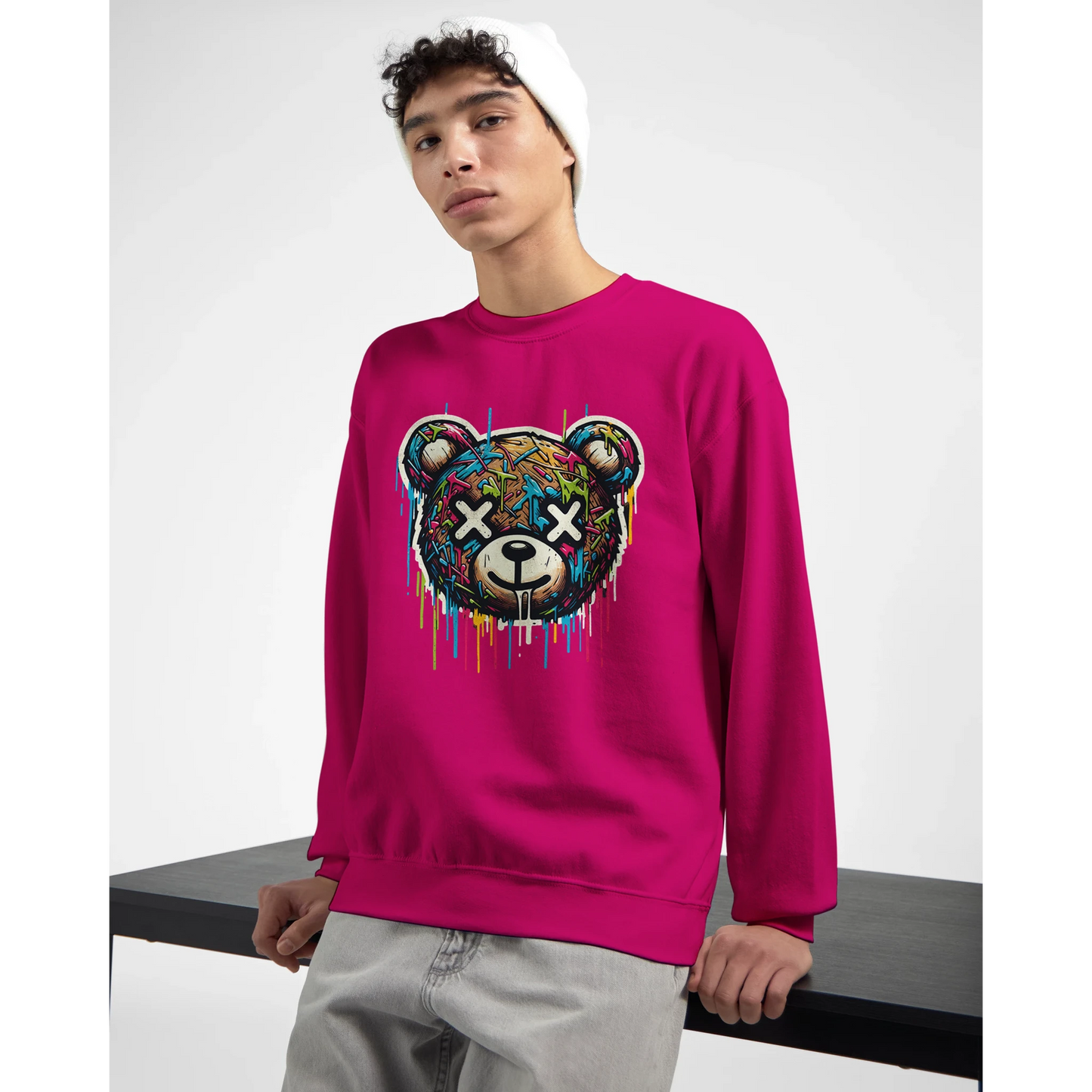 Person wearing a bright pink men's graphic sweatshirt with a colorful bear graphic design. side