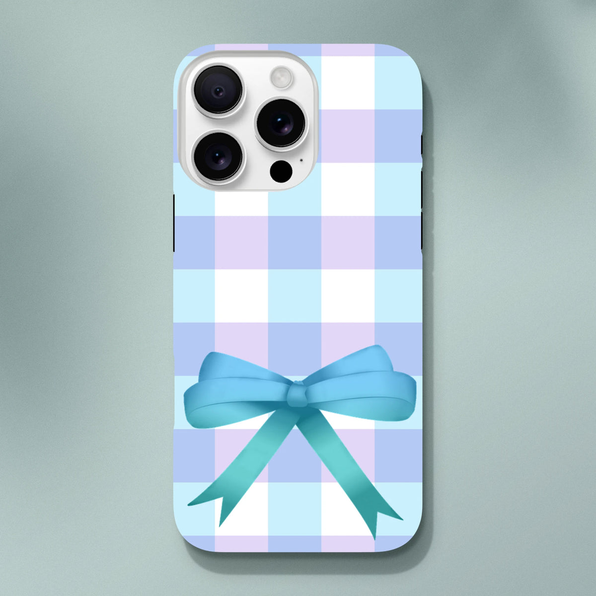 Blue gingham iPhone case with large teal ribbon bow. Pastel check coquette phone cover for streetwear style.