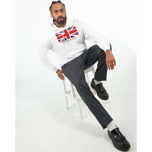 Man sitting on a stool wearing a white men's union jack hoodie with grey pants, and black shoes. 1