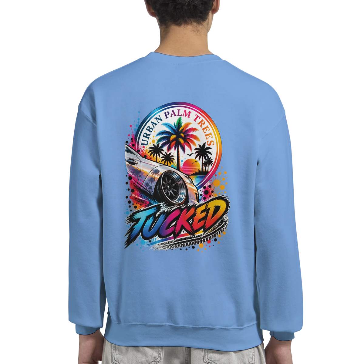 Blue sweatshirt back with colorful Tucked petrolhead graphic, featuring lowered custom car and urban palm trees sunset design.