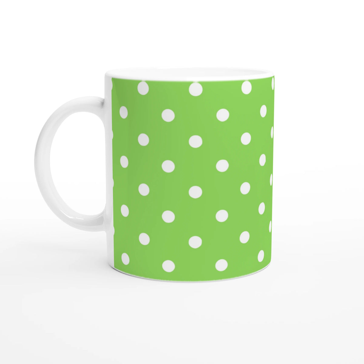 Green ceramic mug featuring white polka dots. Cute spotty coffee cup design for daily tea or coffee drinks.