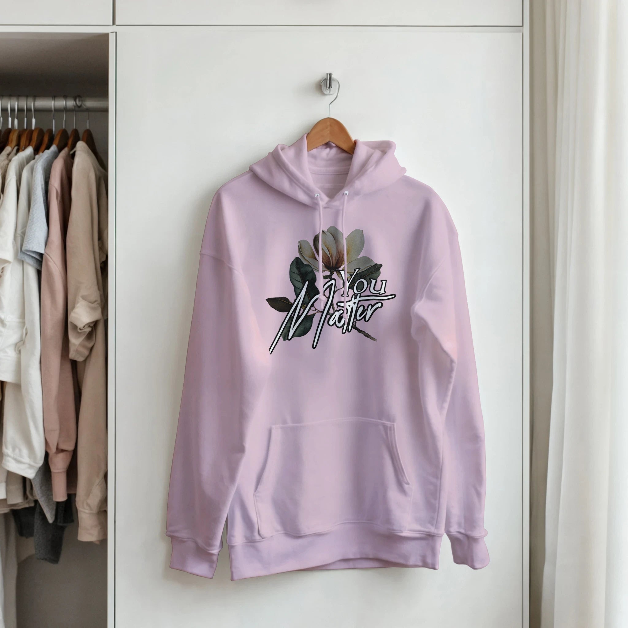 Pastel pink You Matter slogan hoodie for women with floral graphic, front pouch pocket, soft cotton blend.