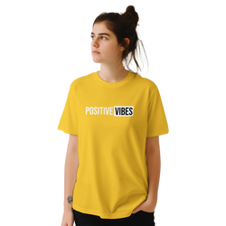 Woman in yellow retro-slogan T-shirt with POSITIVE VIBES print.