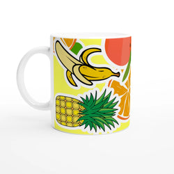 White ceramic coffee mug featuring a vibrant tropical design with banana, pineapple, and orange illustrations.