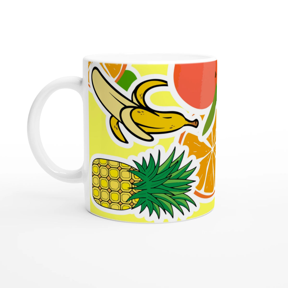 White ceramic coffee mug featuring a vibrant tropical design with banana, pineapple, and orange illustrations.
