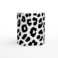Retro Snow Leopard Mug: white ceramic coffee cup with black leopard spots, animal aesthetic