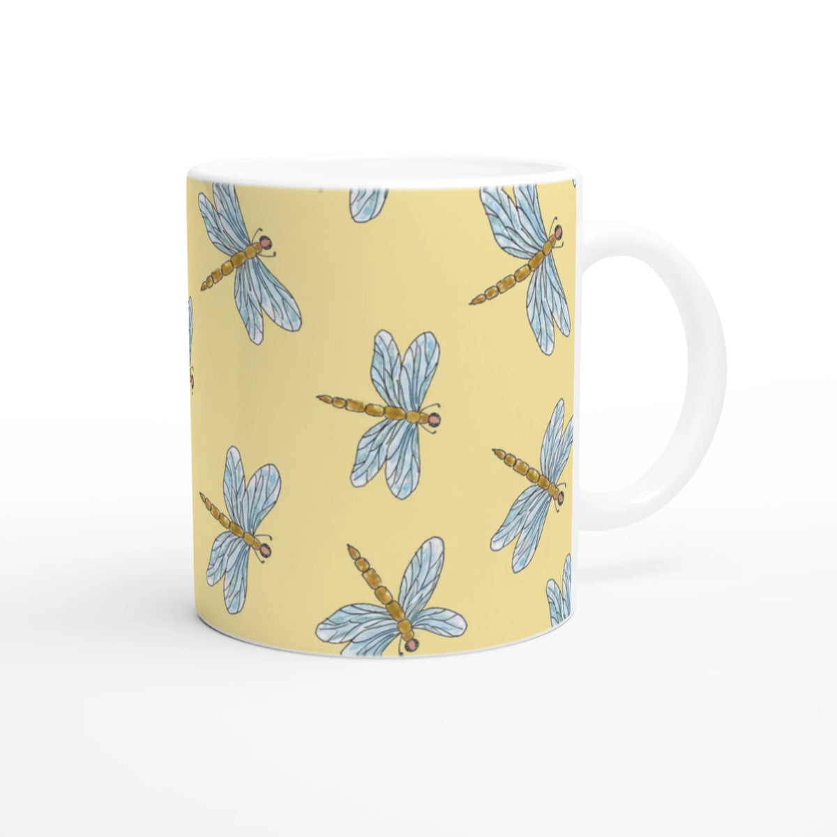 Yellow Dragonfly Mug with blue dragonfly pattern on ceramic, comfortable grip for daily coffee or tea.