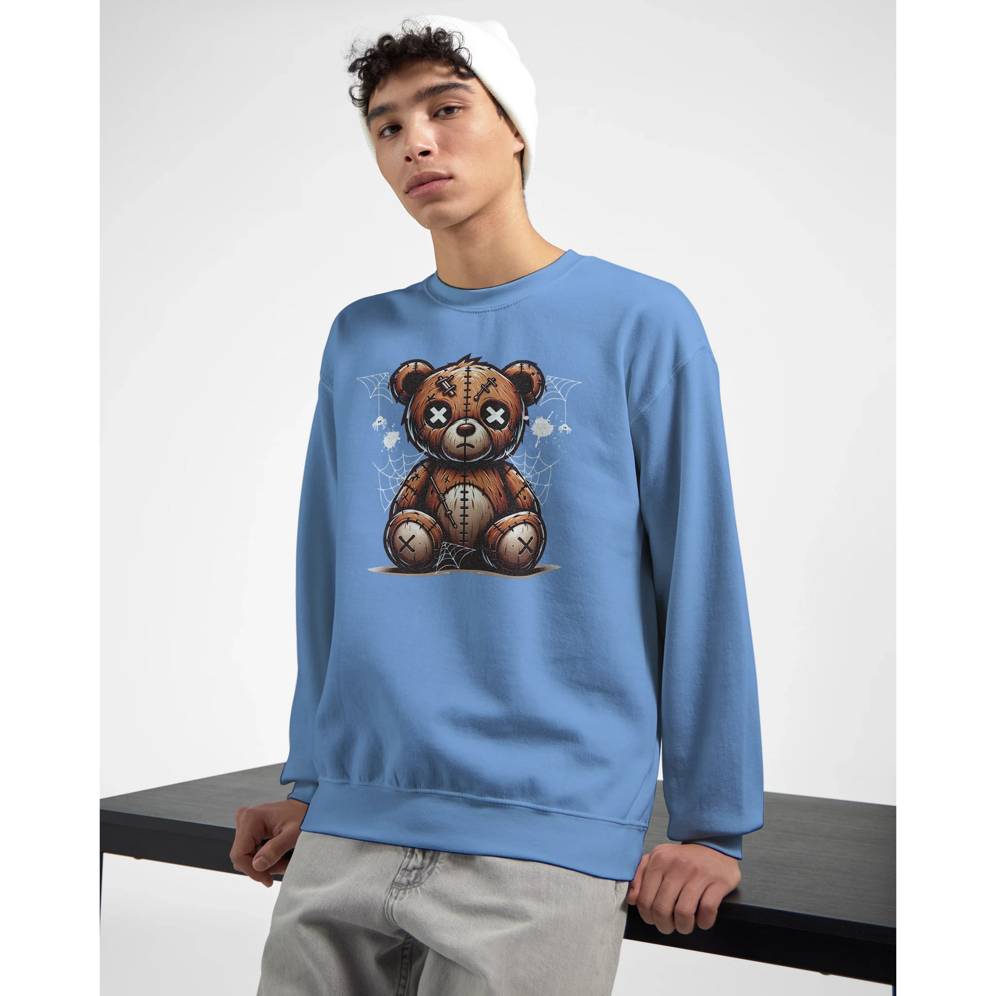 Person wearing a blue men's graphic sweatshirt with a teddy bear graphic on a white background