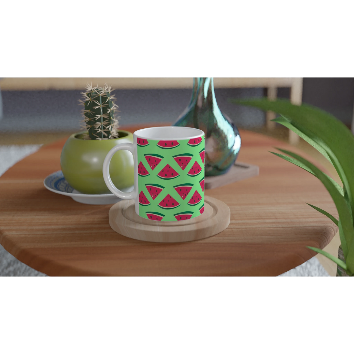 Cute ceramic coffee mug with green summer watermelon pattern on wooden coaster next to potted cactus.