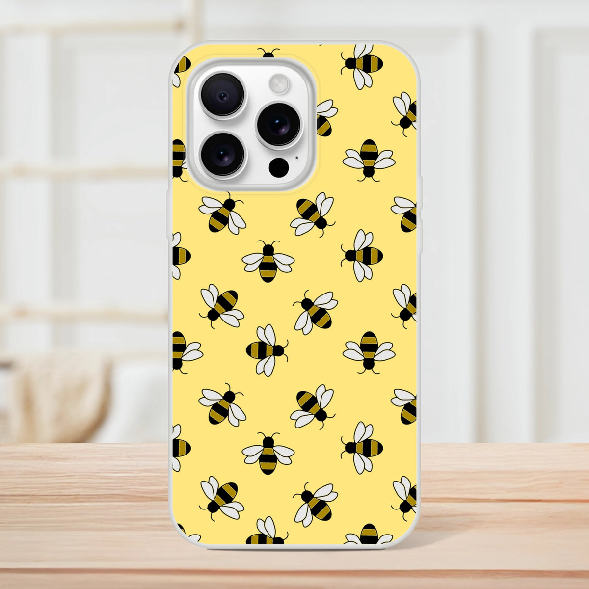 Yellow iPhone case with honey bee pattern for iPhone 13-16, featuring black-and-yellow bees on a sunny background.