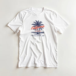 White women's California graphic tee with blue palm tree, California script, and 'Tropical State of Mind' text.