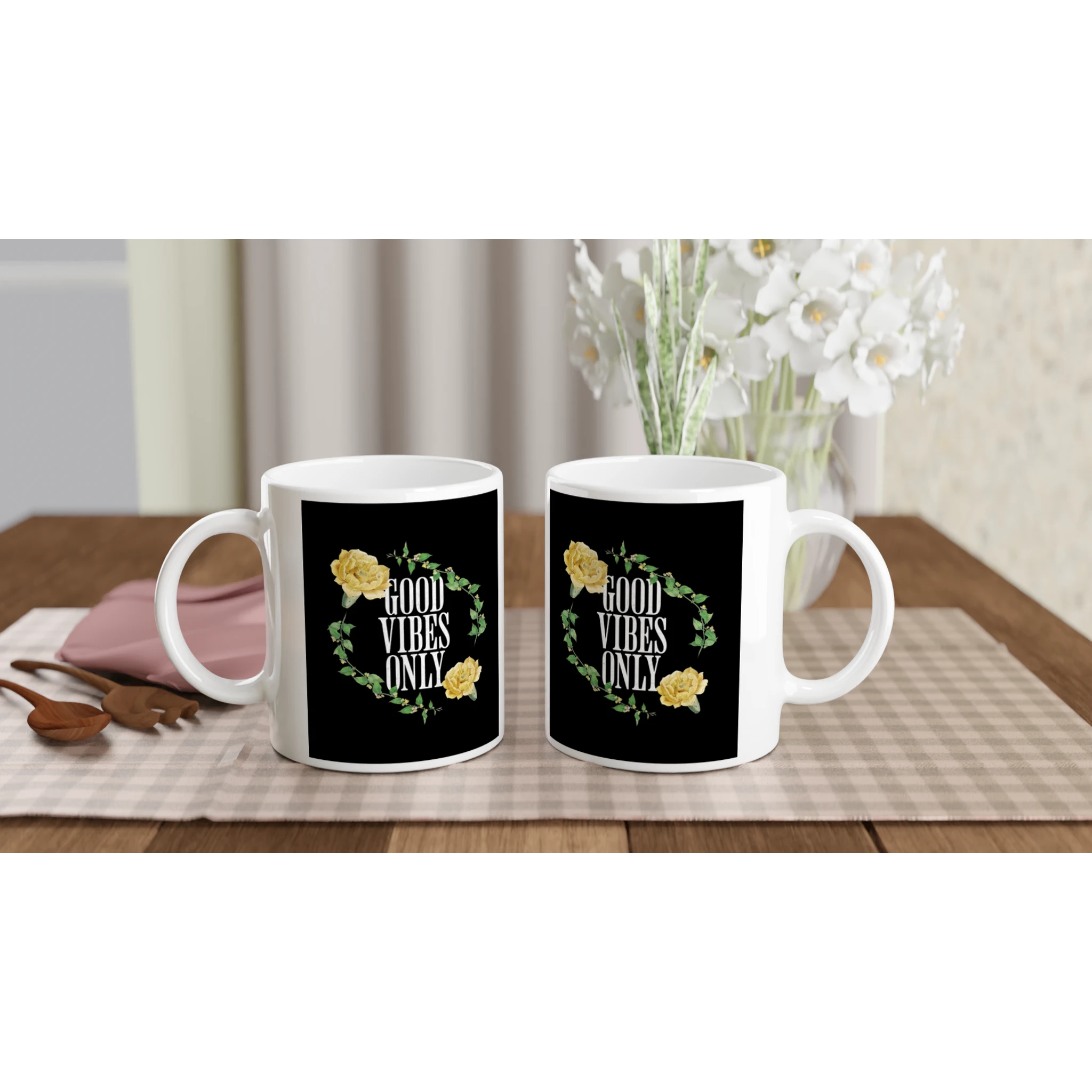 Pair of white ceramic mugs with black panels reading GOOD VIBES ONLY, surrounded by a yellow rose floral wreath.