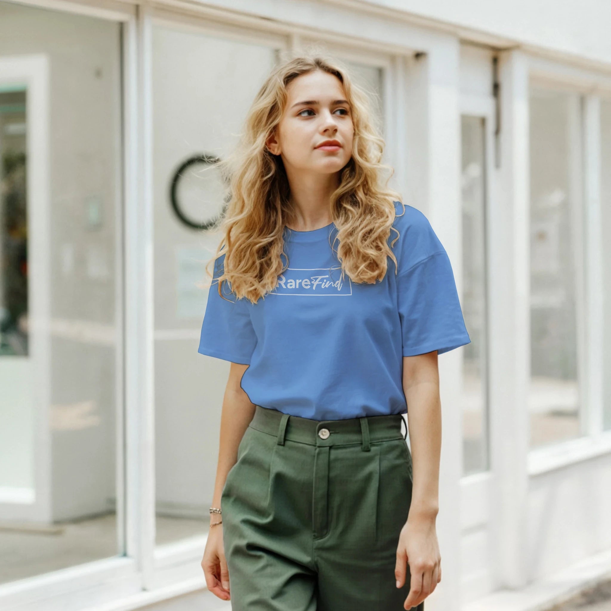 Woman in blue RareFind retro slogan T-shirt outdoors on a city street.
