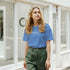 Woman in blue RareFind retro slogan T-shirt outdoors on a city street.