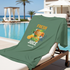 Green T-Shirt with 'Fresh Juice' graphic draped over a lounge chair by a poolside.