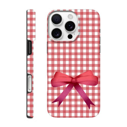 Red gingham iPhone case with a large pink bow back print, featuring a tough coquette design for iOS 13-16 devices.
