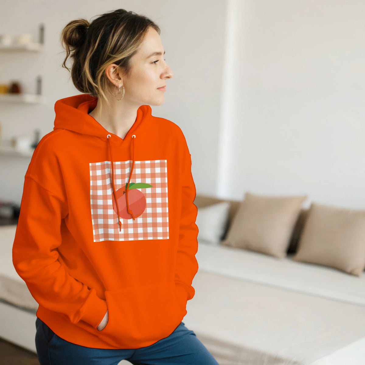 Orange women's hoodie featuring a retro peach graphic on a gingham square. Vintage fruit pullover for casual streetwear style.