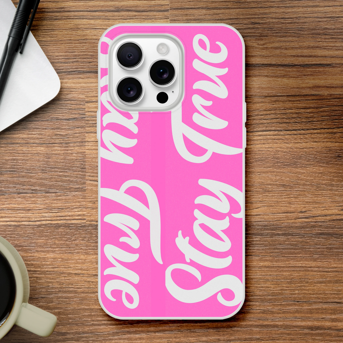 Pink Stay True iPhone case for 13-16 with bold white slogan, streetwear vibe, and protective cover.
