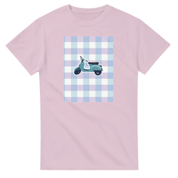 Pastel pink t-shirt featuring a retro scooter graphic on a blue and purple gingham background for a cute streetwear look.