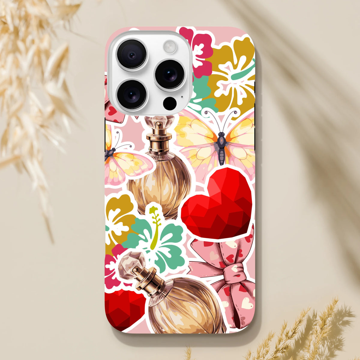Pink floral sticker effect iPhone case featuring perfume bottles, butterflies, and a red heart graphic with tough protection.