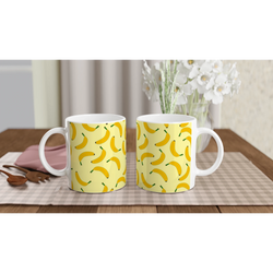 Three yellow banana-pattern coffee mugs on a wooden table.