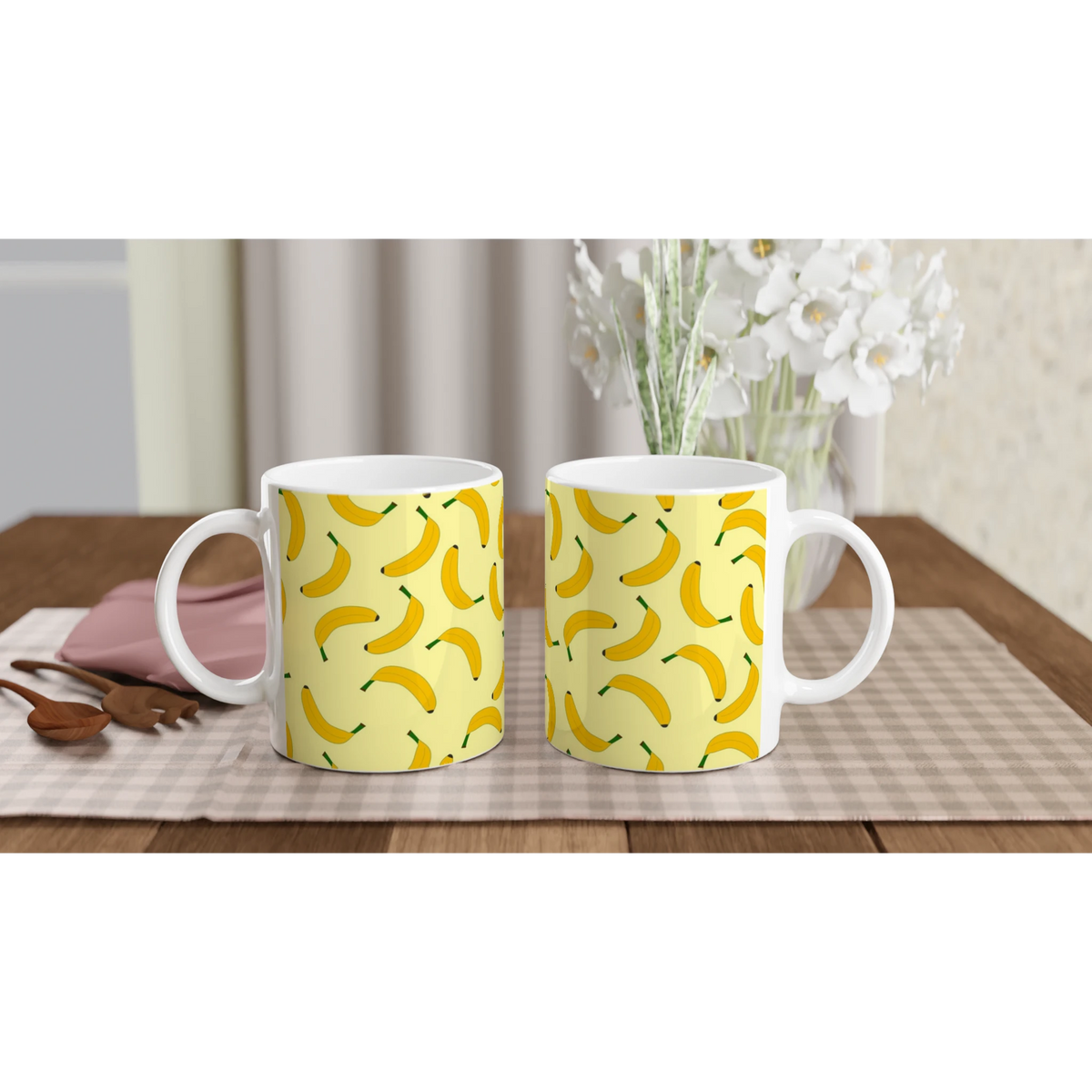 Three yellow banana-pattern coffee mugs on a wooden table.