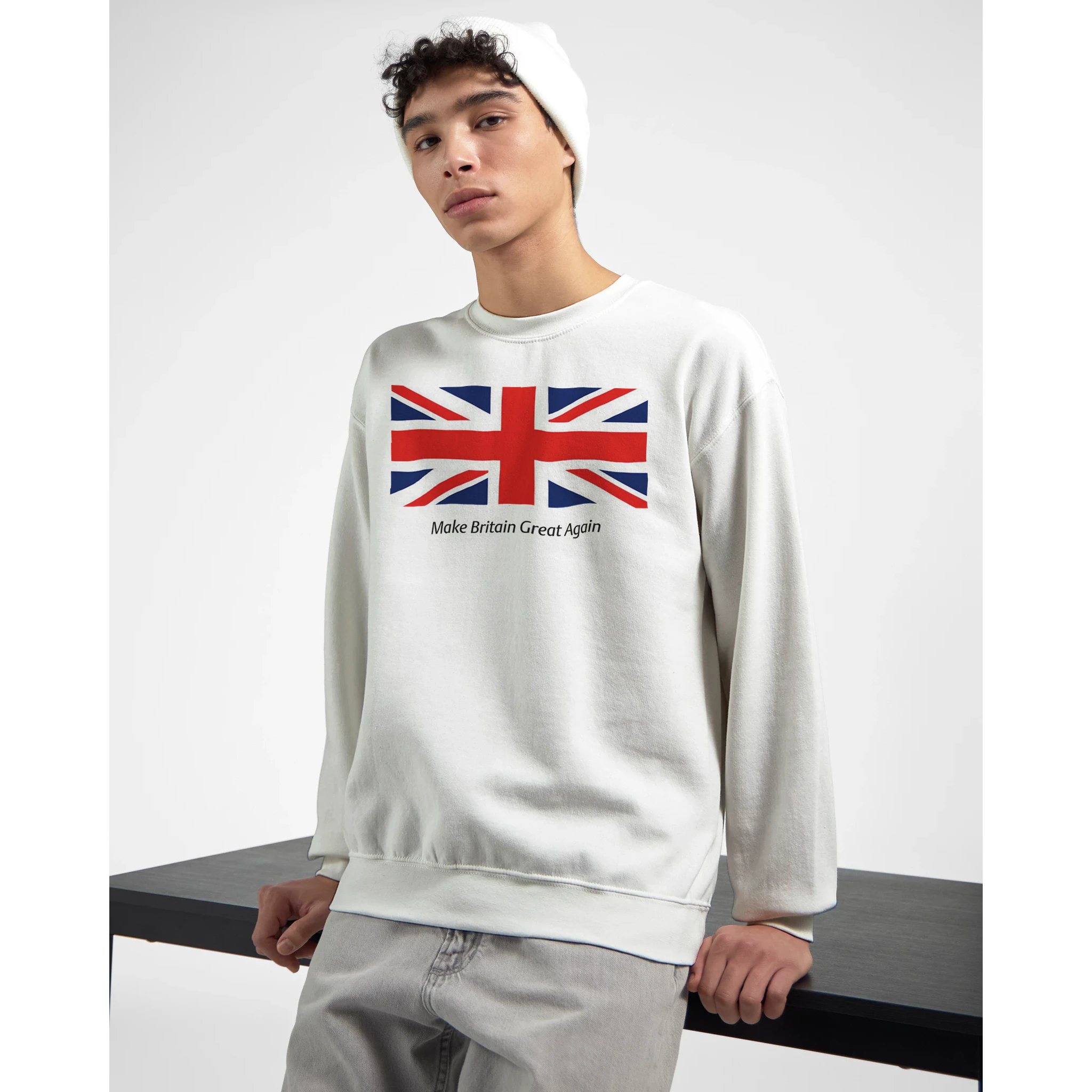 Male model wearing white sweatshirt featuring Union Jack flag and Make Britain Great Again slogan, soft cotton blend.